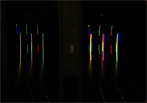   <strong><em>Virtual Color Tubes</em></strong> / 2011
		Lichtinstallation mit 3 fragmentierten Newtonspektren, 4 Wasserprismen (21 x21 x 21 x 50 cm), 3 Spalten, 3 Projektoren, drei Auffangschablonen aus Aluminium (186 x 20,6 x 0,5 cm), 
		Gesamtlänge 18 m (links Blick durchs Prisma). © Ingo Nussbaumer